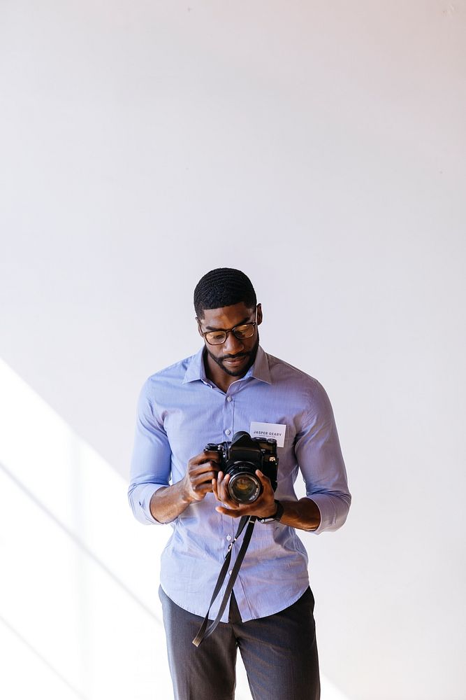 Black photographer using a retro film camera