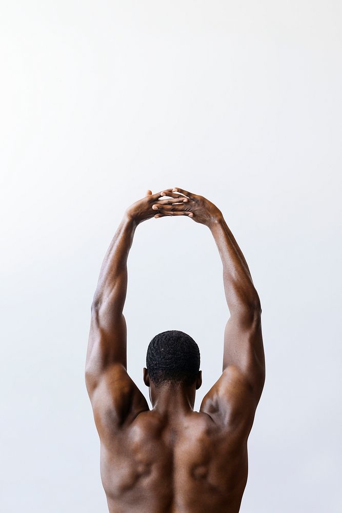 Black man stretching his back muscles