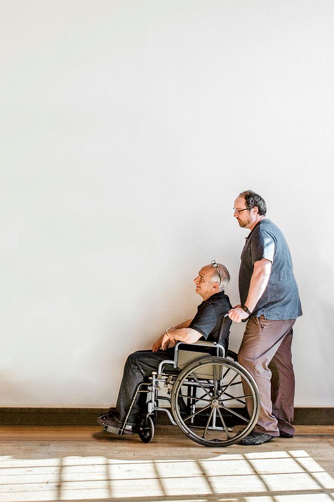 Man pushing his dad's wheelchair