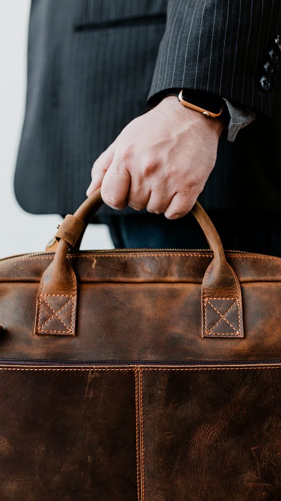 Businessman carrying his brown leather business bag