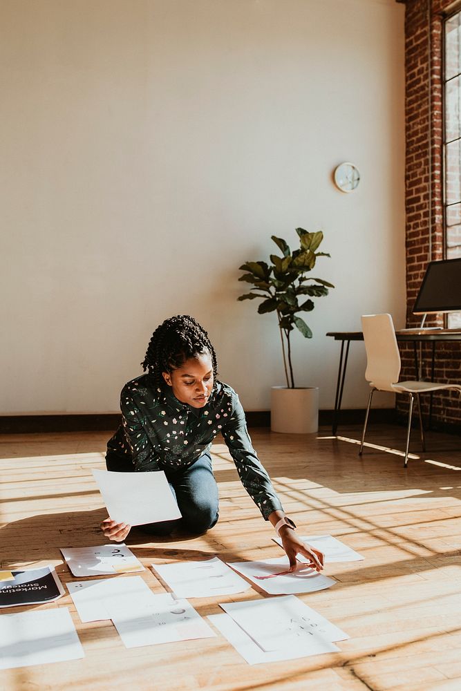 Businesswoman planning a marketing strategy on a wooden floor