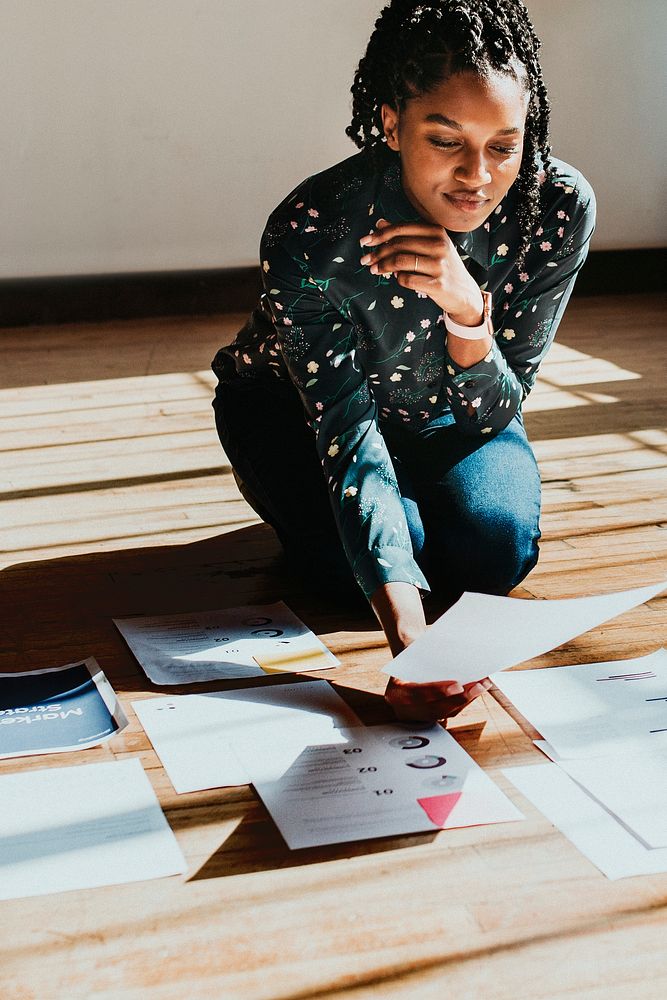 Businesswoman planning a marketing strategy on a wooden floor