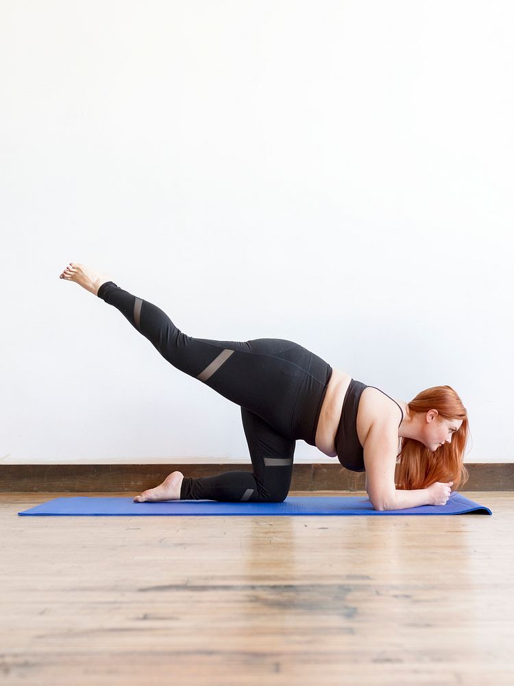Sporty woman stretching on a yoga mat