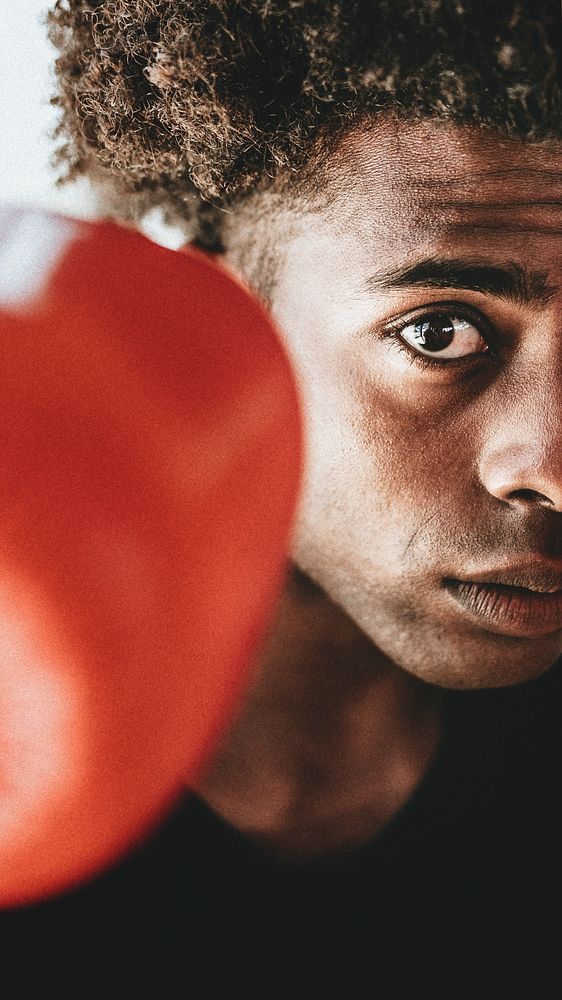 Young fighter wearing boxing gloves mobile phone wallpaper
