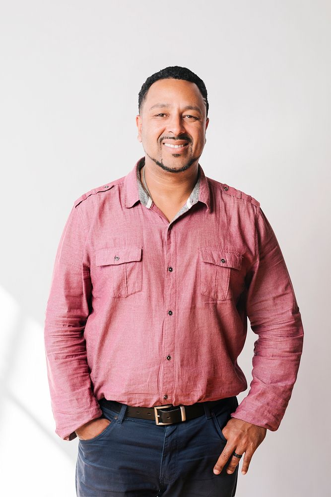 Portrait of a Hispanic man in a pink shirt