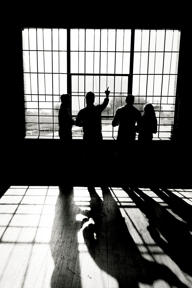 Eco-friendly engineering team discussing by the glass windows grayscale