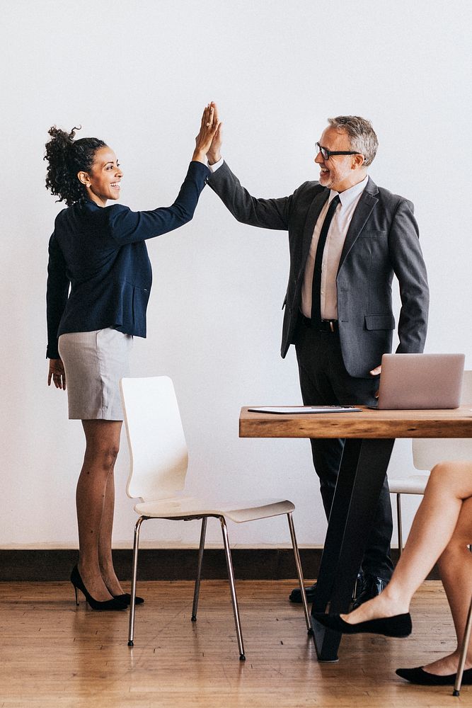 Business people doing a high five