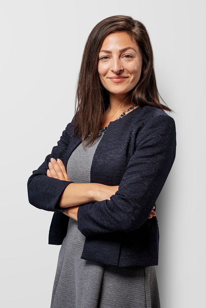 Happy businesswoman with arms crossed