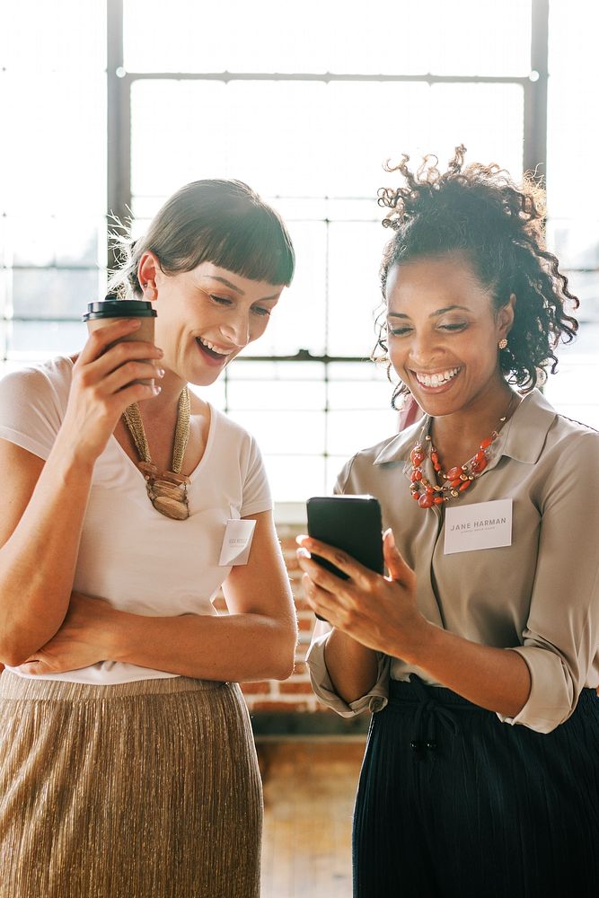 Businesswomen sharing online content from a phone
