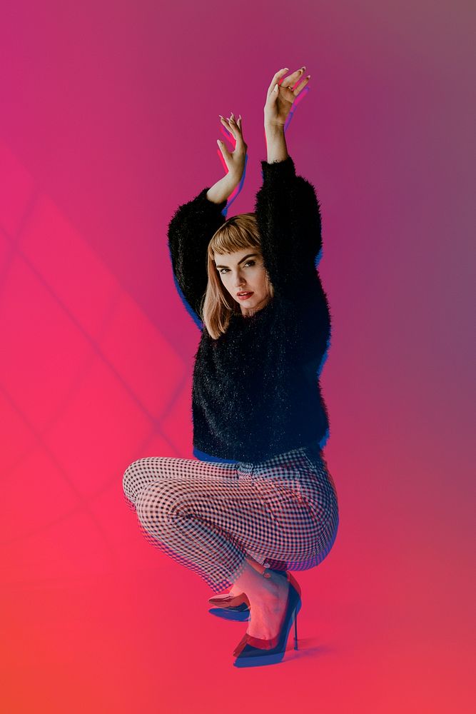 Brown hair woman in a black fluffy sweater crouching on high heels mockup