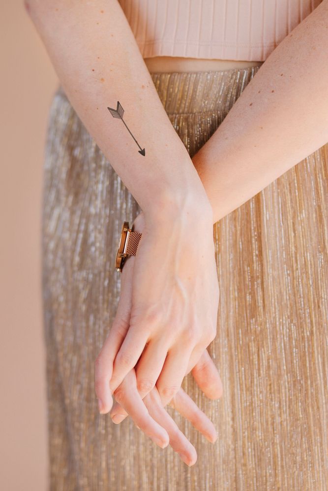 Arrow tattoo on woman's wrist