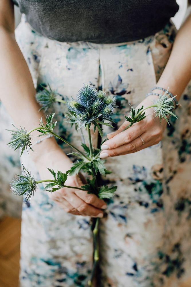 Woman holding a blue thistle