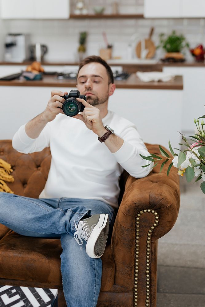 Photographer sitting on the couch looking at images
