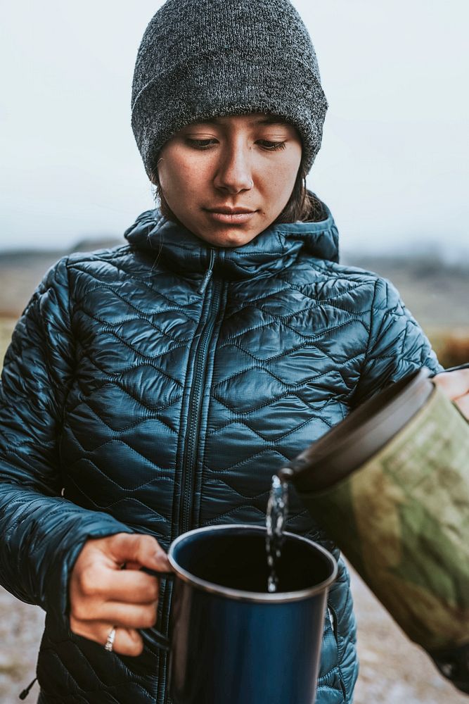 Woman pouring hot water into a mug