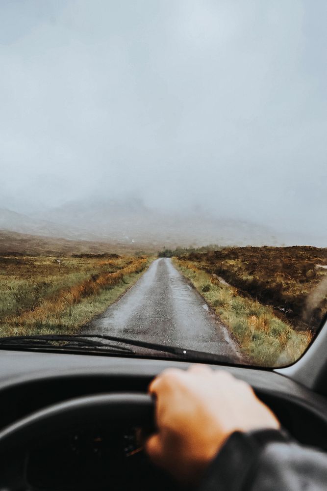 Man driving in a car in the highlands