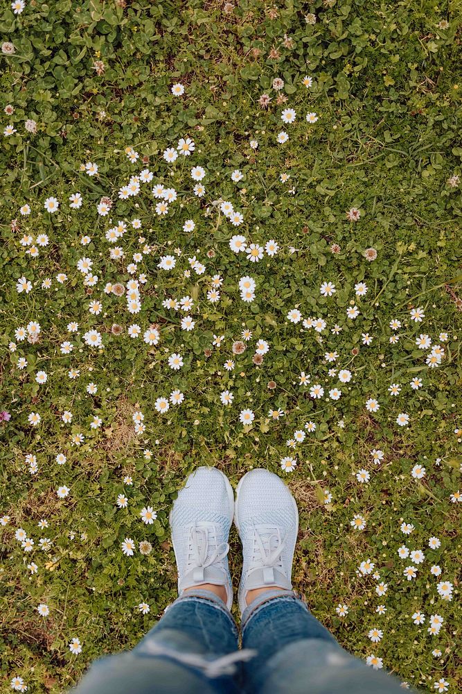 Woman in a gray sneaker standing on a grass