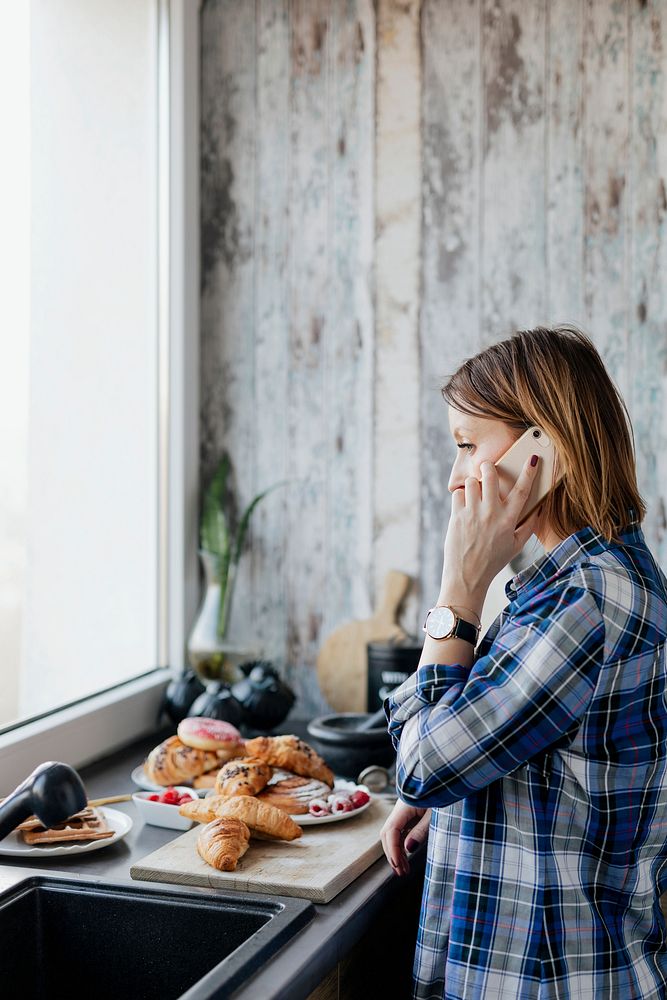 Woman talking on a phone while preparing brunch