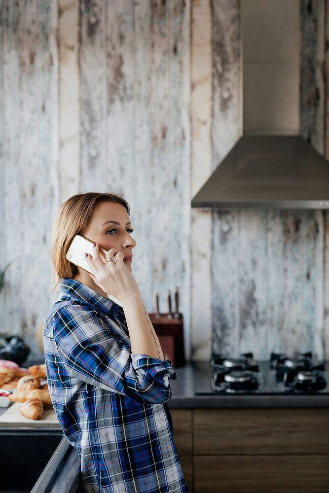 Woman talking on the phone in the kitchen