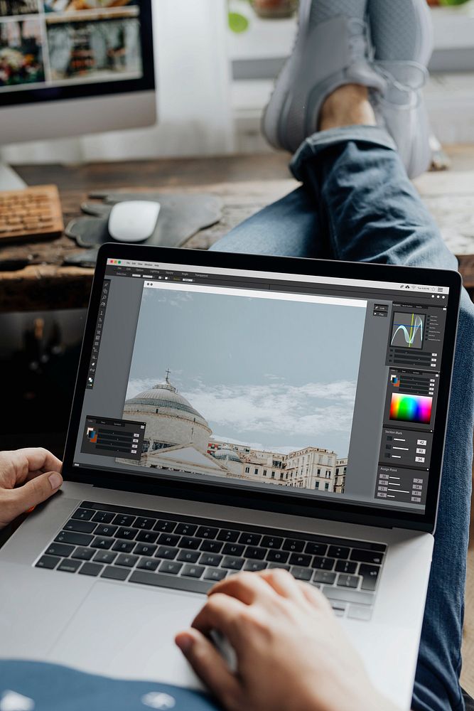 Photographer editing images on his laptop