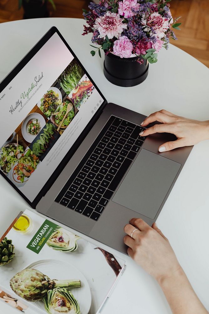 Woman looking at healthy vegetarian recipes on her laptop