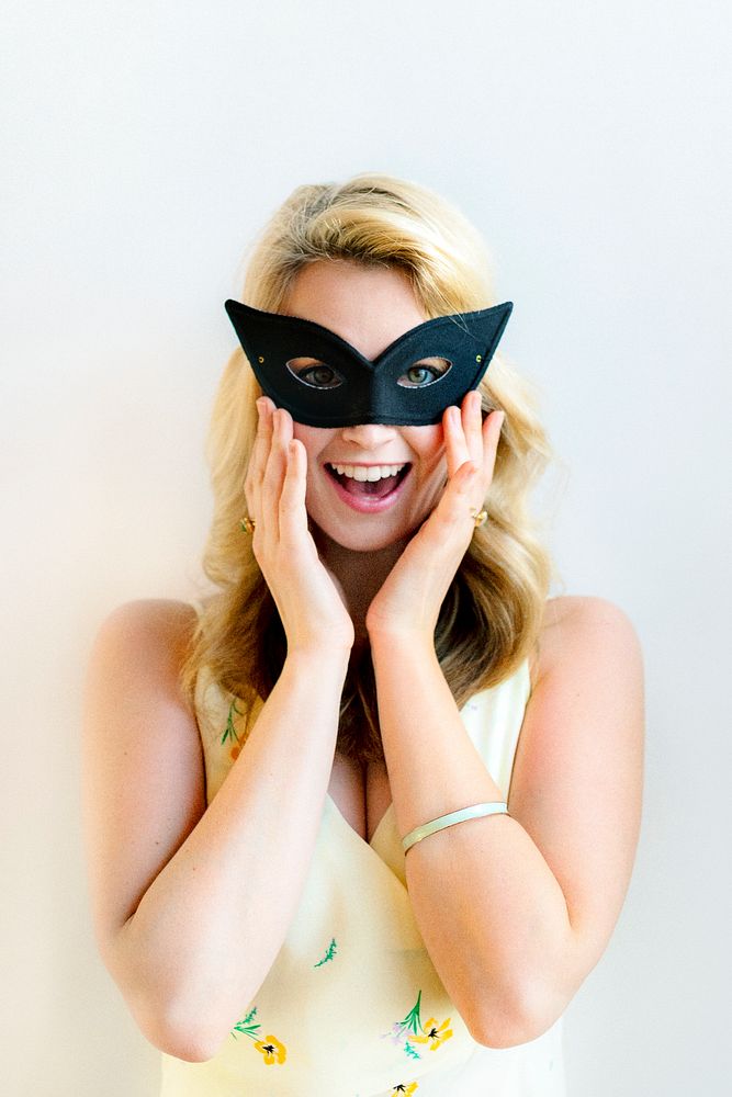 Cheerful woman with mask at the party