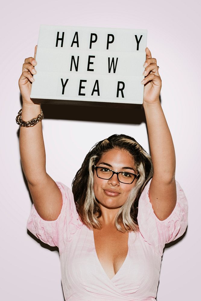 Woman with glasses raising happy new year board mockup