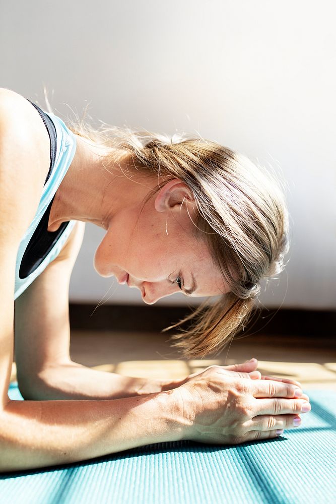Sportive woman doing elbow plank on the floor