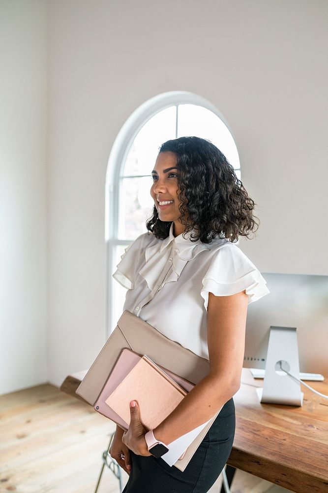 Black businesswoman carrying a digital device