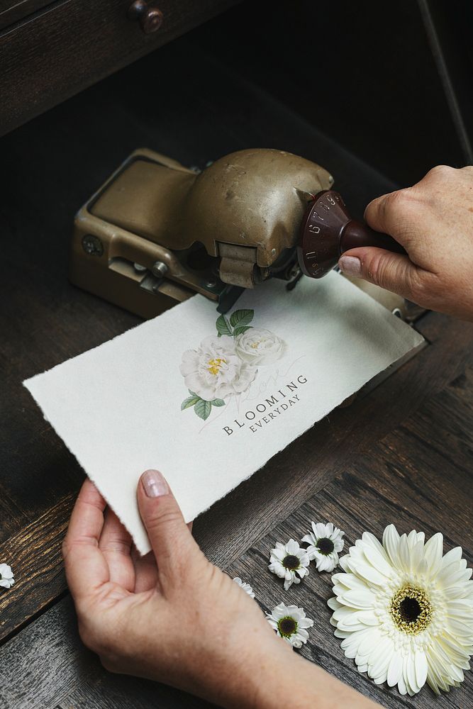 Woman using a vintage hold puncher with a card mockup