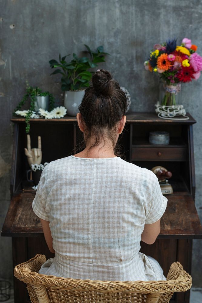 Woman sitting by an old wooden desk