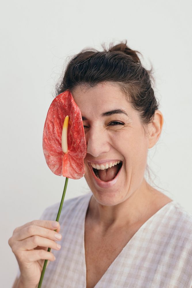 Smiling woman holding a flaming flower