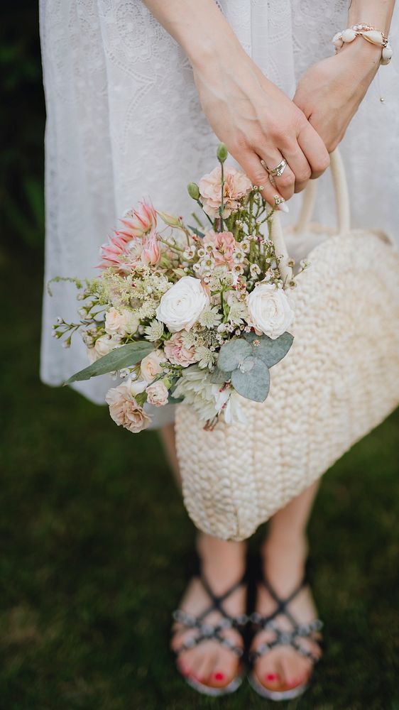 Woman with a woven bag full of flowers