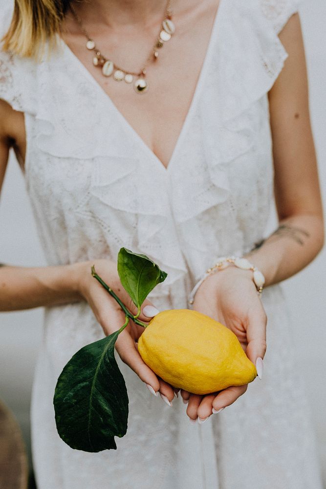 Woman holding a fresh lemon