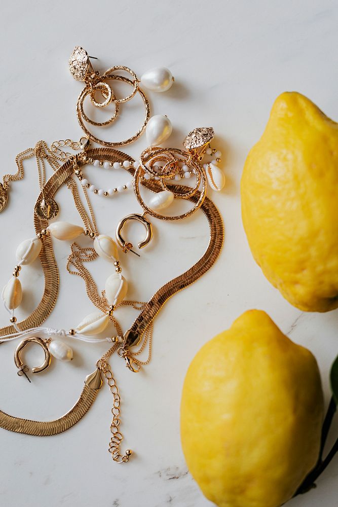 Fresh lemons by the gold jewelries