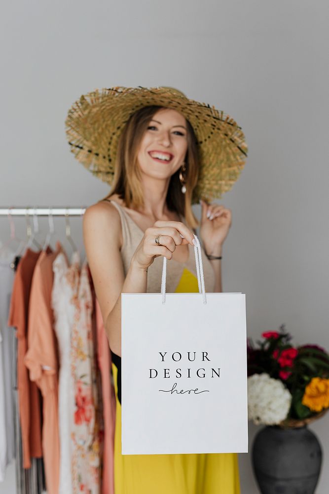 Happy woman carrying a shopping paper bag mockup