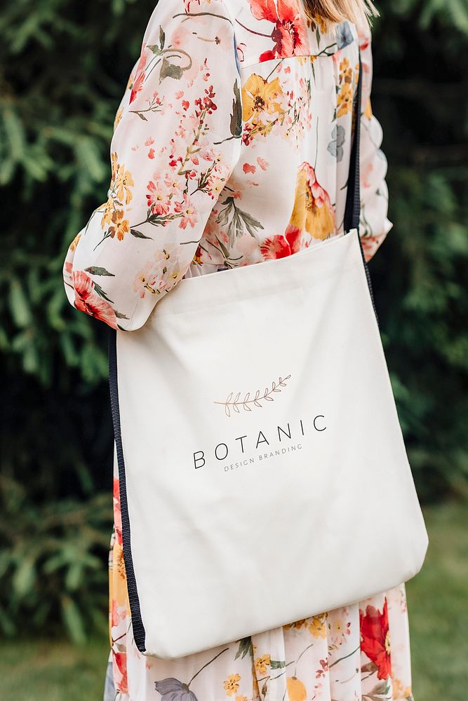 Woman in a floral dress with a tote bag