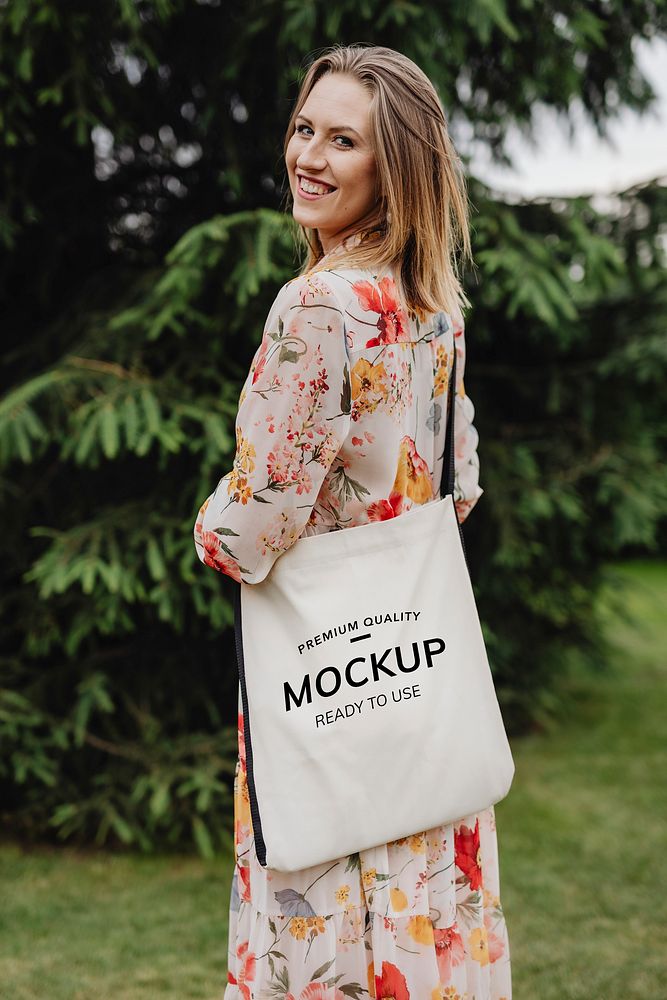 Woman in a floral dress with a tote bag