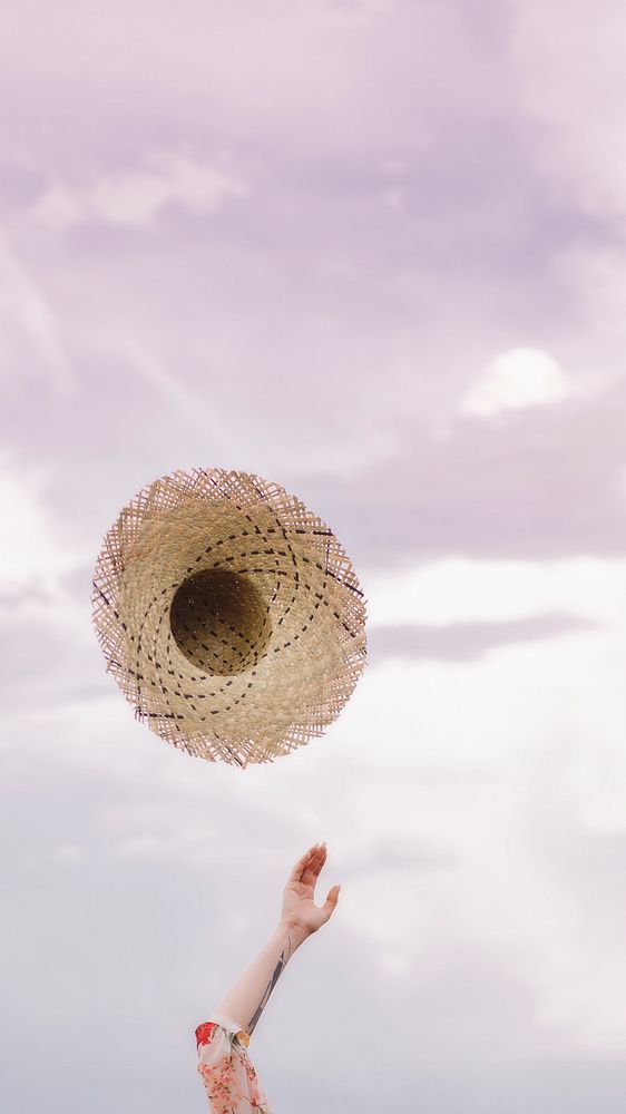Woman throwing hat into the air