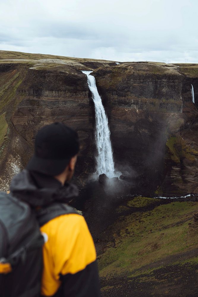 Man at the Haifoss waterfall, Iceland
