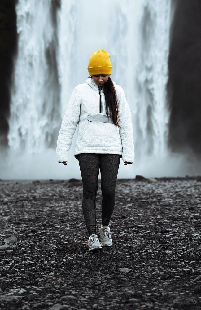 Woman standing in front of  Sk&oacute;gafoss waterfall, Iceland