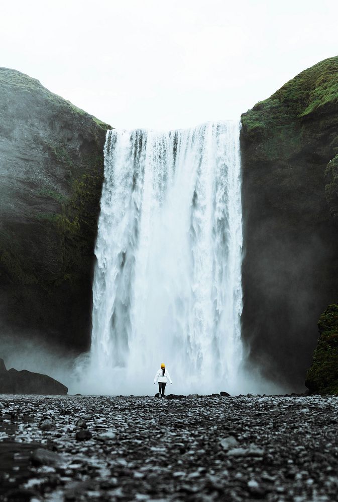 Woman standing in front of Sk&oacute;gafoss waterfall, Iceland
