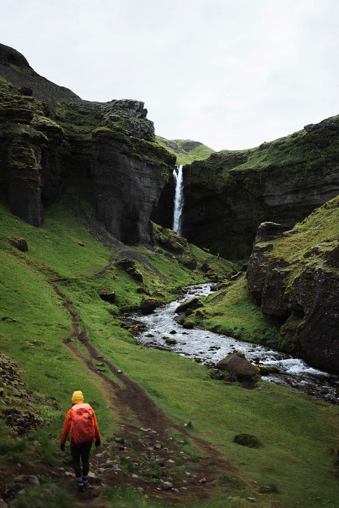 Female hiker with a view of Kvernufoss waterfall in South Iceland