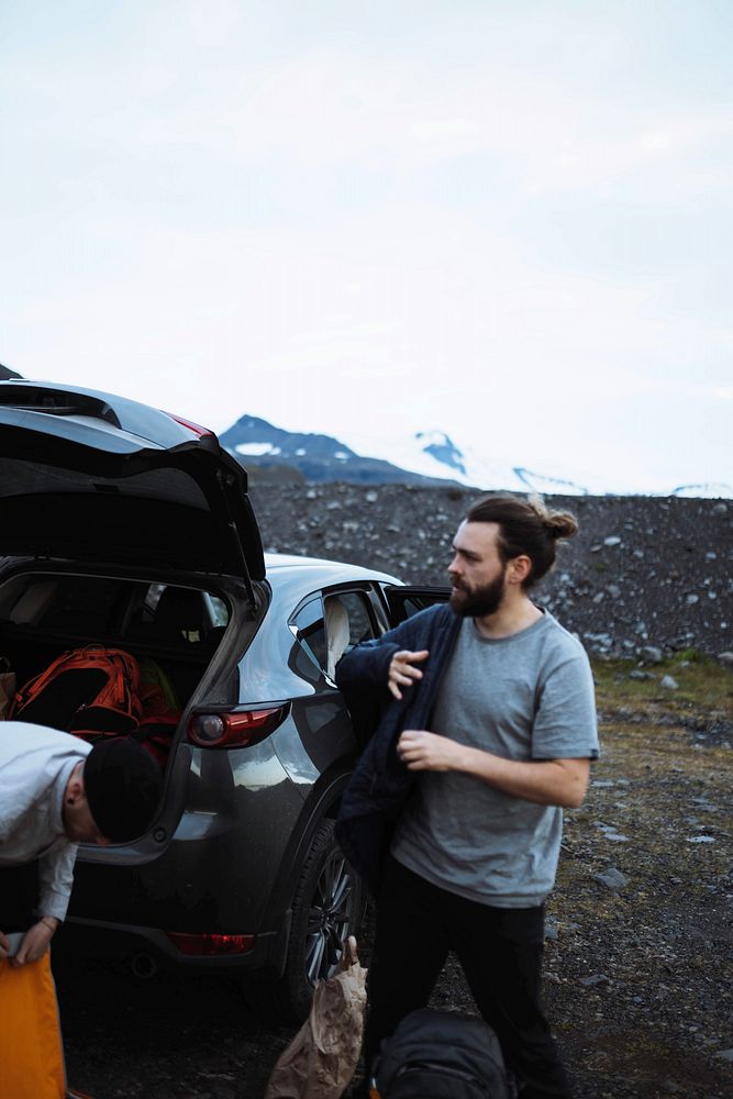 Hikers getting stuff from the car boot