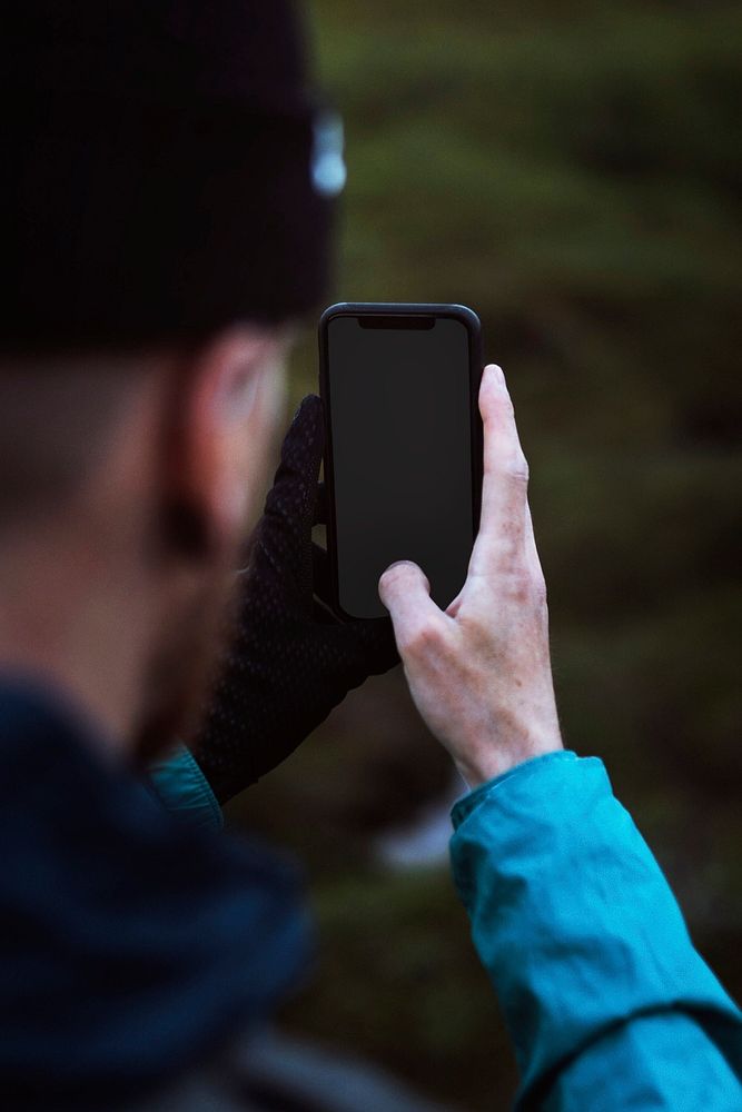 Man using a phone mockup in a countryside