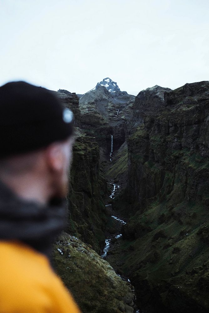 Man with a view of a waterfall in Iceland