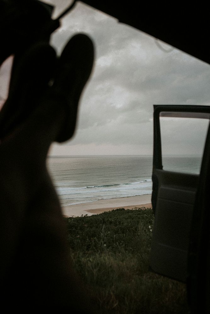 Man chilling in his car by the ocean