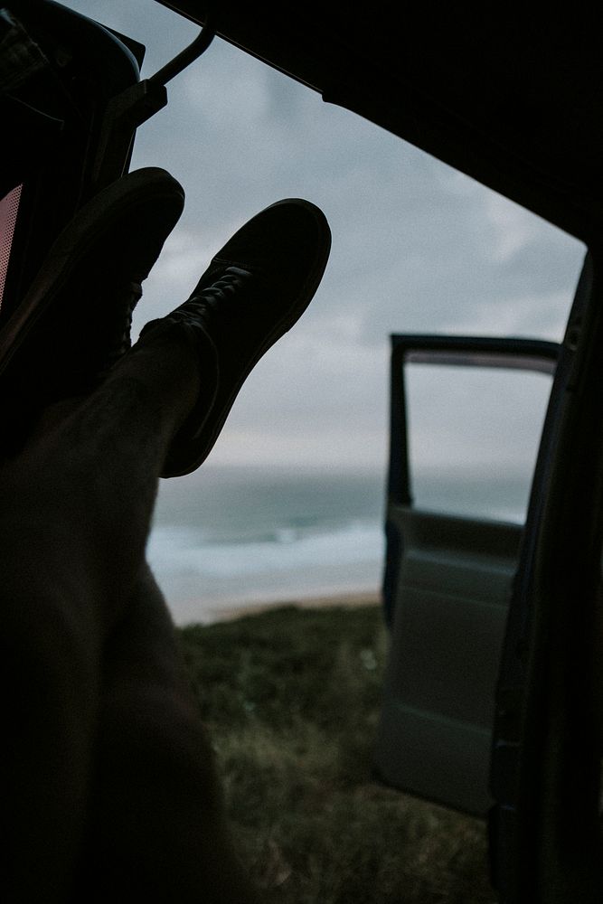 Man chilling in his car by the ocean