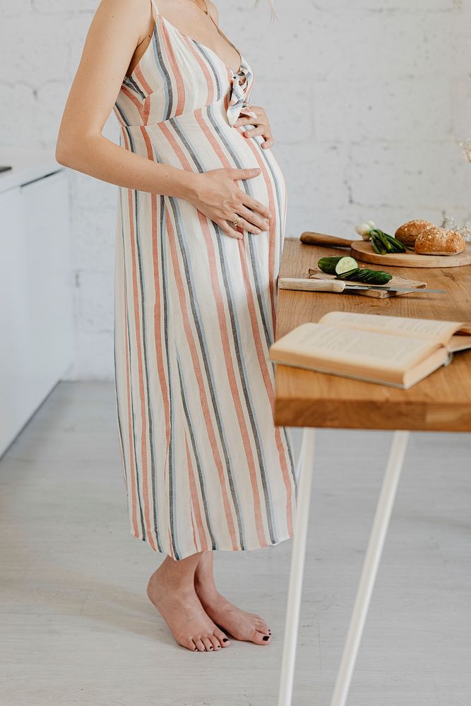 Pregnant woman cooking in a kitchen