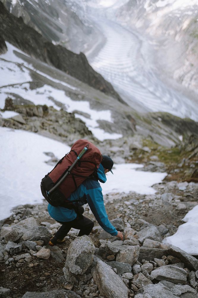 Backpacker hiking down Chamonix Alps in France