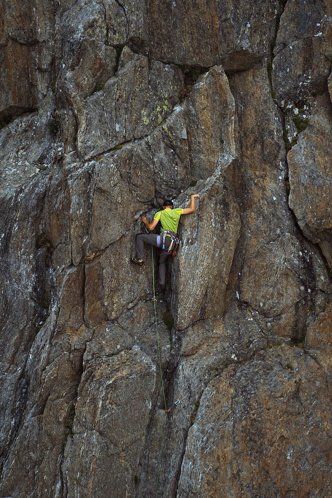 Rock climber working his way up Chamonix Alps in France